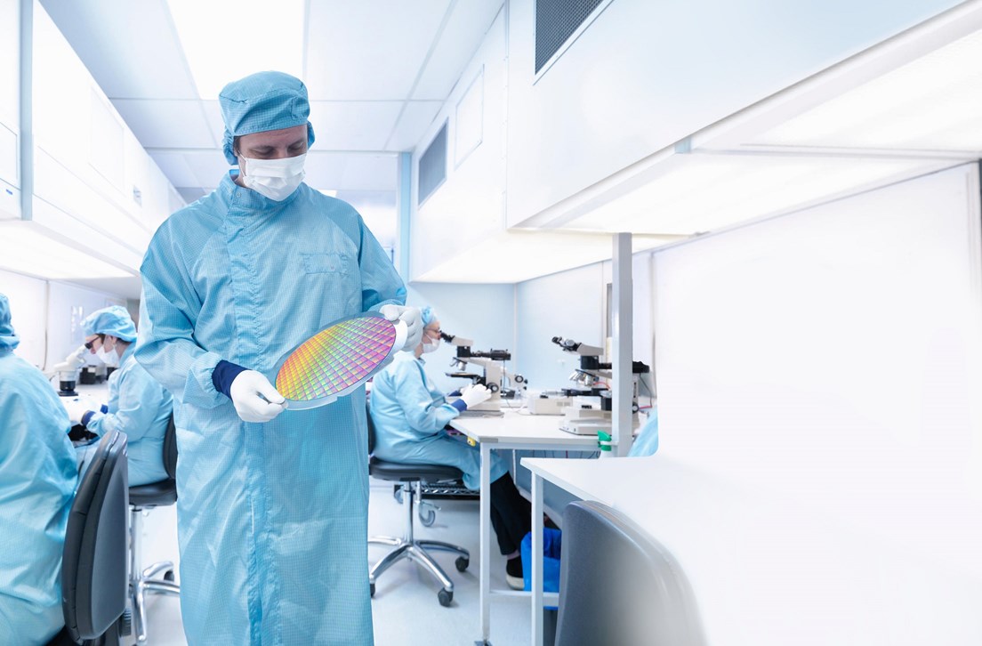 EXFABT Electronics worker in clean room holding silicon wafer EXFABT Electronics worker in clean room holding silicon wafer